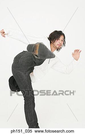Portrait of a young man kicking View Large Photo Image Stock Photography - Portrait of a young man kicking. Fotosearch