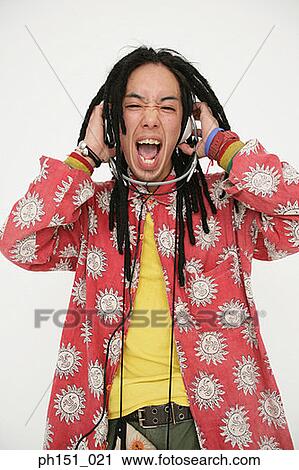 Portrait of a young man listening to music and shouting View Large Photo Image Stock Image - Portrait of a young man listening to music and shouting. Fotosearch