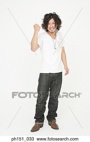 Portrait of a young man making a fist and smiling View Large Photo Image Stock Image - Portrait of a young man making a fist and smiling. Fotosearch