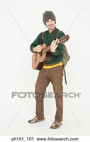 Portrait of a young man playing the guitar and smiling View Large Photo Image Stock Image - Portrait of a young man playing the guitar and smiling. Fotosearch