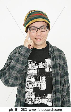 Portrait of a young man smiling and pointing up View Large Photo Image Stock Image - Portrait of a young man smiling and pointing up. Fotosearch