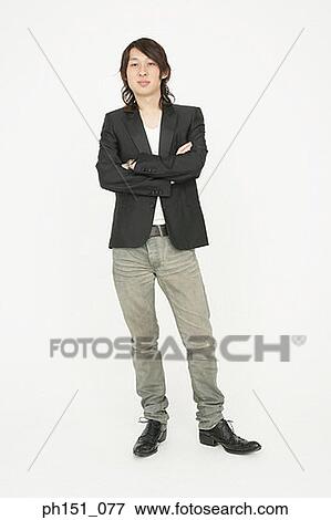 Portrait of a young man smiling with his arms crossed View Large Photo Image Stock Photo - Portrait of a young man smiling with his arms crossed. Fotosearch