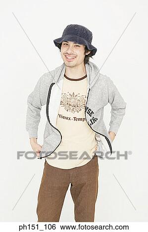 Portrait of a young man smiling with his hands on his hips View Large Photo Image Stock Photograph - Portrait of a young man smiling with his hands on his hips. Fotosearch