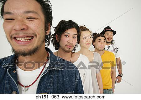 Portrait of a young man standing in a line with his friends and posing View Large Photo Image Stock Image - Portrait of a young man standing in a line with his friends and posing. Fotosearch