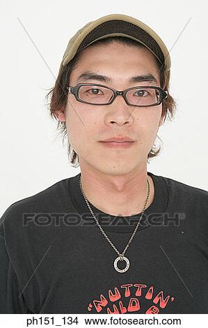 Portrait of a young man wearing eyeglasses View Large Photo Image Picture - Portrait of a young man wearing eyeglasses. Fotosearch