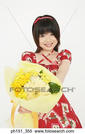 Portrait of a young woman holding a bouquet of flowers View Large Photo Image Stock Photography - Portrait of a young woman holding a bouquet of flowers. Fotosearch