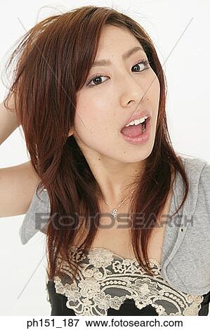 Portrait of a young woman looking surprised View Large Photo Image Stock Photo - Portrait of a young woman looking surprised. Fotosearch