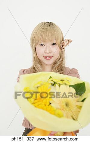 Stock Photo - Portrait of a young woman showing a bouquet of flowers. Fotosearch
