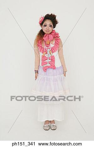Portrait of a young woman standing and posing View Large Photo Image Stock Image - Portrait of a young woman standing and posing. Fotosearch