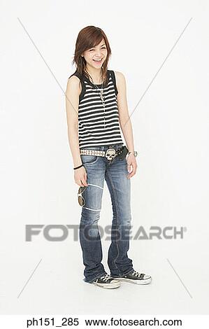 Portrait of a young woman standing and smiling View Large Photo Image Stock Photography - Portrait of a young woman standing and smiling. Fotosearch