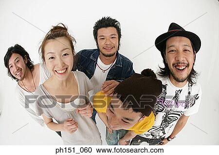 Portrait of a young woman standing with four young men and looking cheerful View Large Photo Image Stock Image - Portrait of a young woman standing with four young men and looking cheerful. Fotosearch