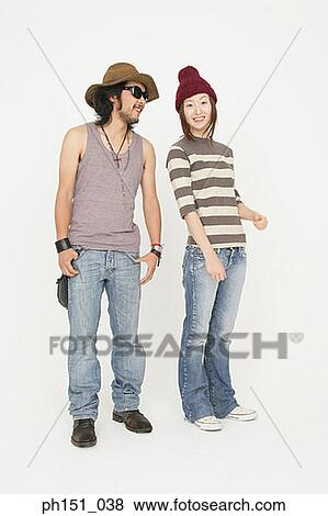 Portrait of a young woman standing with a young man and smiling View Large Photo Image Stock Photo - Portrait of a young woman standing with a young man and smiling. Fotosearch