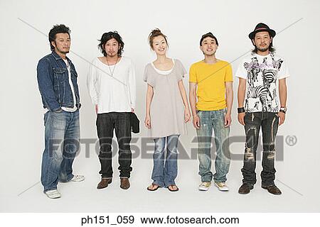 Portrait of a young woman standing with four young men and smiling View Large Photo Image Stock Photo - Portrait of a young woman standing with four young men and smiling. Fotosearch