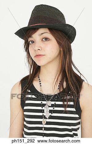 Stock Image - Portrait of a young woman wearing a hat. Fotosearch