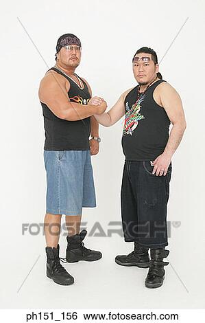 Portrait of two mid adult men arm wrestling View Large Photo Image Stock Photograph - Portrait of two mid adult men arm wrestling. Fotosearch