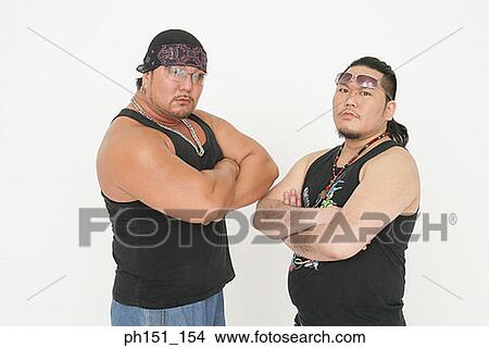 Portrait of two mid adult men standing with their arms crossed View Large Photo Image Picture - Portrait of two mid adult men standing with their arms crossed. Fotosearch