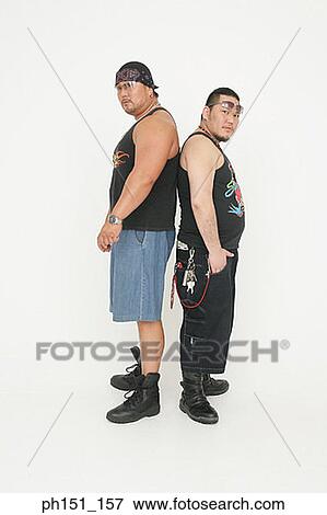 Portrait of two mid adult men standing back to back View Large Photo Image Stock Photo - Portrait of two mid adult men standing back to back. Fotosearch