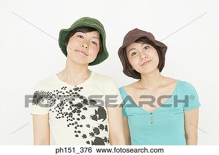Portrait of two young women smirking View Large Photo Image Stock Photograph - Portrait of two young women smirking. Fotosearch