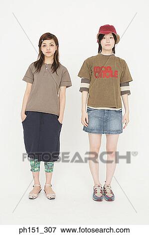 Stock Photo - Portrait of two young women standing. Fotosearch