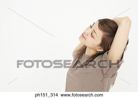 Side profile of a young woman stretching View Large Photo Image Picture - Side profile of a young woman stretching. Fotosearch