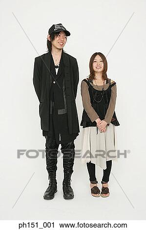 Young couple standing together and smiling View Large Photo Image Stock Image - Young couple standing together and smiling. Fotosearch