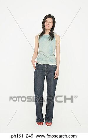 Young woman standing and smiling View Large Photo Image Stock Photo - Young woman standing and smiling. Fotosearch