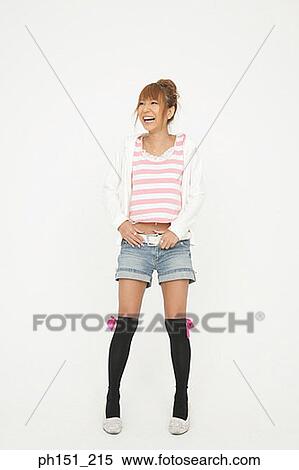 Young woman standing and smiling View Large Photo Image Stock Photography - Young woman standing and smiling. Fotosearch