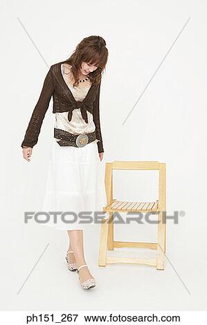 Stock Photo - Young woman walking and looking down. Fotosearch