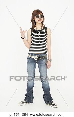 Young woman wearing sunglasses and smiling View Large Photo Image Picture - Young woman wearing sunglasses and smiling. Fotosearch