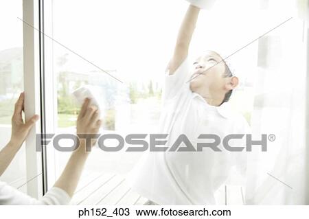 Close-up of a boy cleaning a window View Large Photo Image Stock Image - Close-up of a boy cleaning a window. Fotosearch