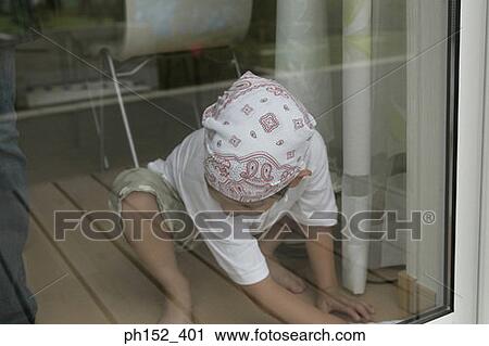 Close-up of a boy crouching View Large Photo Image Stock Image - Close-up of a boy crouching. Fotosearch
