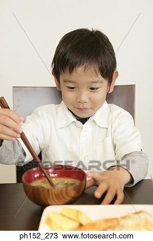 Close-up of a boy holding a pair of chopsticks View Large Photo Image Stock Image - Close-up of a boy holding a pair of chopsticks. Fotosearch