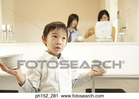 Close-up of a boy holding bowls View Large Photo Image Stock Image - Close-up of a boy holding bowls. Fotosearch
