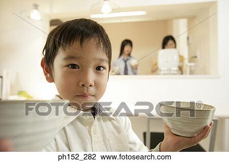 Close-up of a boy holding bowls View Large Photo Image Stock Image - Close-up of a boy holding bowls. Fotosearch