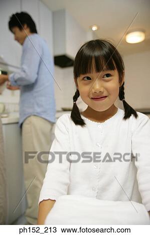 Close-up of a girl carrying a stack of folded towels View Large Photo Image Stock Image - Close-up of a girl carrying a stack of folded towels. Fotosearch