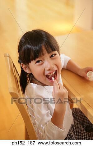 Close-up of a girl eating a gelatin dessert View Large Photo Image Stock Photo - Close-up of a girl eating a gelatin dessert. Fotosearch