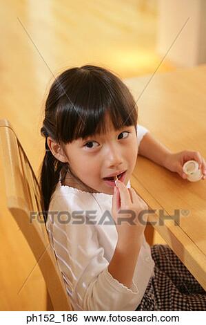 Close-up of a girl eating a gelatin dessert View Large Photo Image Stock Photograph - Close-up of a girl eating a gelatin dessert. Fotosearch