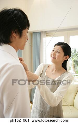 Close-up of a mid adult woman adjusting a mid adult man's tie View Large Photo Image Stock Image - Close-up of a mid adult woman adjusting a mid adult man's tie. Fotosearch