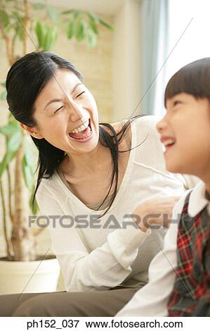 Close-up of a mid adult woman and her daughter laughing View Large Photo Image Stock Photo - Close-up of a mid adult woman and her daughter laughing. Fotosearch