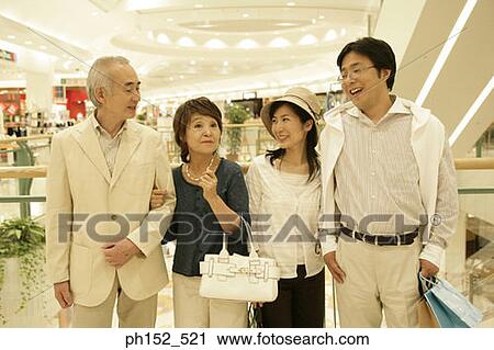 Close-up of a senior couple and a mid adult couple in a shopping mall View Large Photo Image Stock Image - Close-up of a senior couple and a mid adult couple in a shopping mall. Fotosearch
