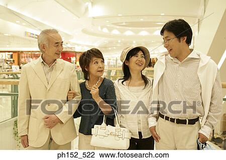 Close-up of a senior couple and a mid adult couple in a shopping mall View Large Photo Image Stock Image - Close-up of a senior couple and a mid adult couple in a shopping mall. Fotosearch