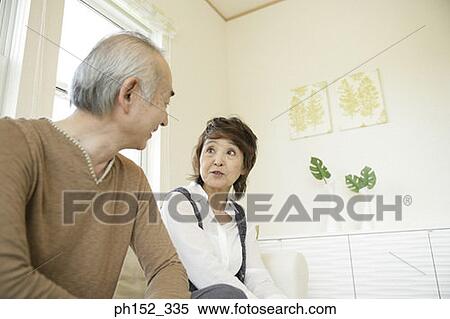 Stock Photography - Close-up of a senior couple sitting on a couch. Fotosearch