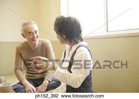 Close-up of a senior couple sitting together View Large Photo Image Stock Image - Close-up of a senior couple sitting together. Fotosearch