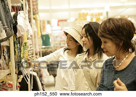 Close-up of a senior woman and her daughter and her granddaughter in a clothing store View Large Photo Image Stock Image - Close-up of a senior woman and her daughter and her granddaughter in a clothing store. Fotosearch