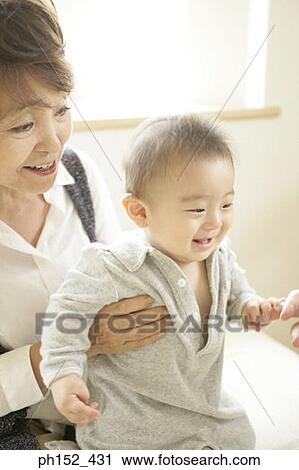 Close-up of a senior woman holding her grandson View Large Photo Image Stock Image - Close-up of a senior woman holding her grandson. Fotosearch