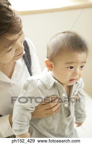 Stock Photo - Close-up of a senior woman holding her grandson. Fotosearch