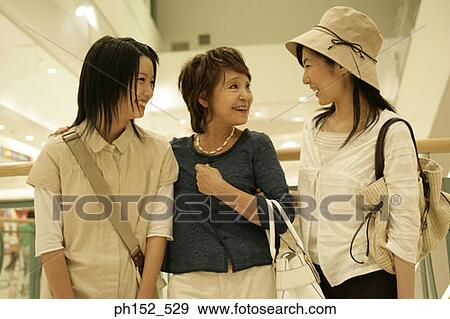 Close-up of a senior woman with her daughter and her granddaughter in a shopping mall View Large Photo Image Stock Photo - Close-up of a senior woman with her daughter and her granddaughter in a shopping mall. Fotosearch