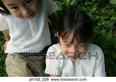 Close-up of two girls View Large Photo Image Stock Photo - Close-up of two girls. Fotosearch