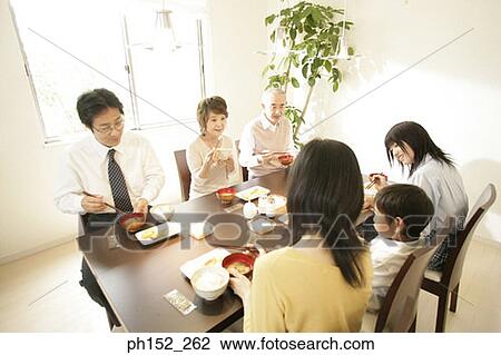 Family at the dining table View Large Photo Image Stock Image - Family at the dining table. Fotosearch