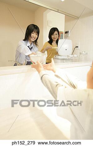 Girl giving a bowl to his brother View Large Photo Image Stock Photo - Girl giving a bowl to his brother. Fotosearch